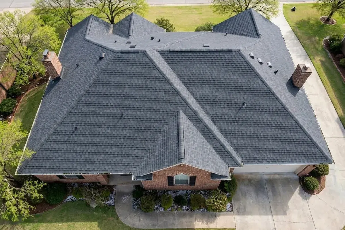 New cool-roof shingles with ridge vent after energy efficiency roof upgrade in Spring, TX